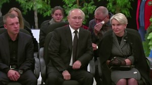 Putin shows rare emotion at funeral for Russian minister